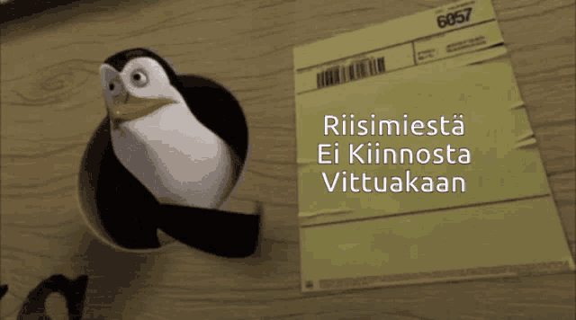 a penguin is sticking its head out of a hole next to a piece of paper that says riismiesta