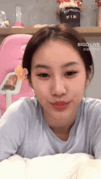 a woman is laying on a bed with bigo live written on the bottom