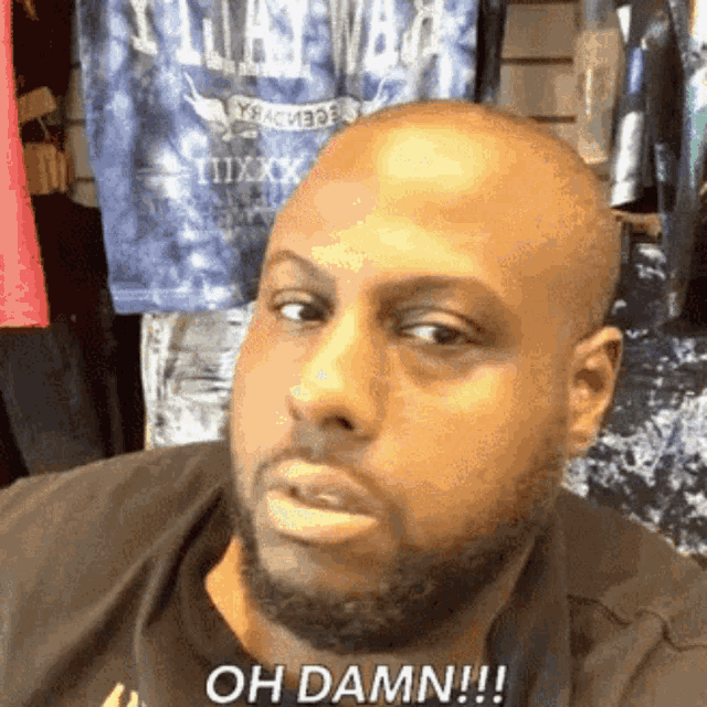 a man with a beard is making a funny face and says oh damn !!!