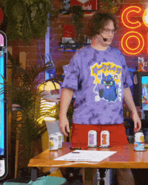 a man wearing a tie dye t-shirt with a cat on it