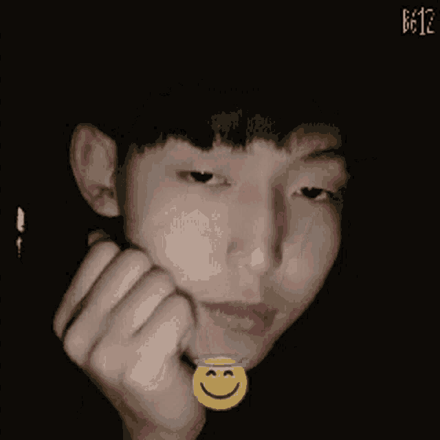 a person with a smiley face on their finger pointing