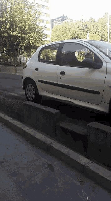 a white car is parked on the side of a street