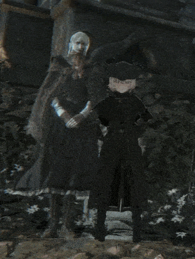a man and a woman are standing next to each other in a dark room