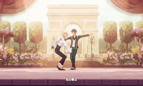 two men are dancing on a stage in front of a building with flowers
