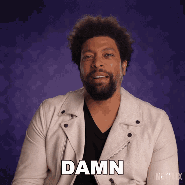 a man in a white jacket says the word damn in front of a purple background