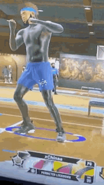 a man is playing a video game on a basketball court .