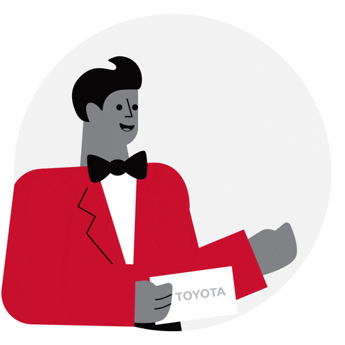 a man in a tuxedo is holding a toyota sign