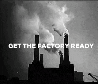a black and white photo of a factory with smoke coming out of it and the words `` get the factory ready '' .