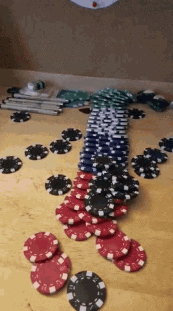 a bunch of poker chips on a table with one that says ' a ' on it