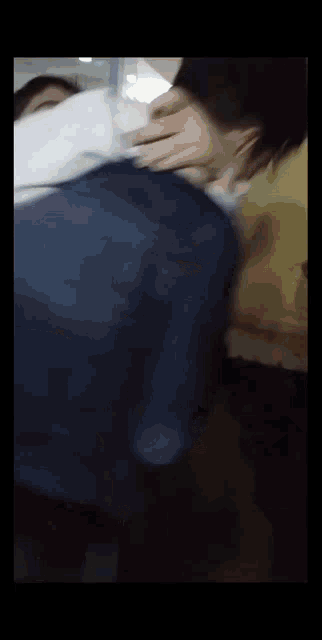 a blurry picture of a person 's back with a blue jacket on