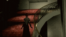 a woman in a dress is walking down a set of stairs .