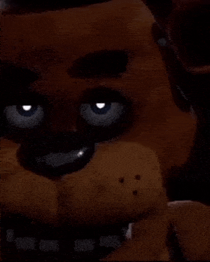 a close up of freddy fazbear from five nights at freddy 's holding a microphone in his mouth .