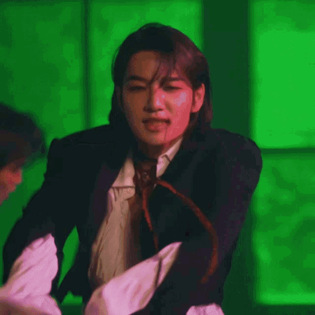 a man with long hair and a choker on his neck