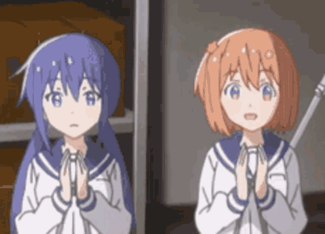 two anime girls are standing next to each other with their hands folded .