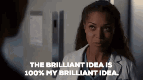 a woman in a lab coat is talking to a man and says `` the brilliant idea is 100 % my brilliant idea '' .