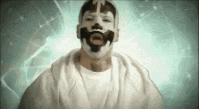 a man with a mask on his face is wearing a white shirt and a white hoodie .