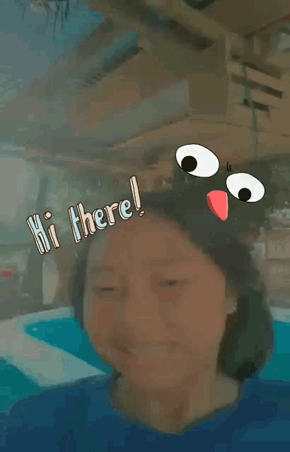 a girl in a blue shirt is standing in front of a pool and says hi there