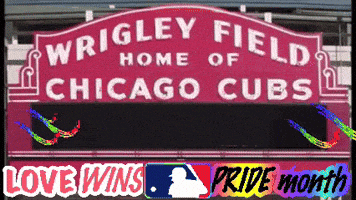 a sign for wrigley field home of the chicago cubs says pride month