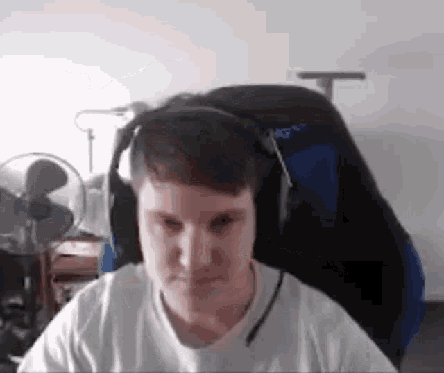 a man wearing headphones is sitting in a chair in a room .