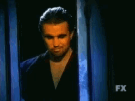 a man in a dark room with fx on the bottom right