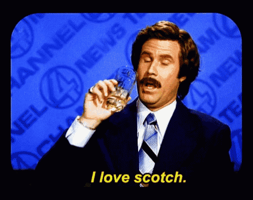 a man in a suit and tie holds a glass of whiskey and says i love scotch