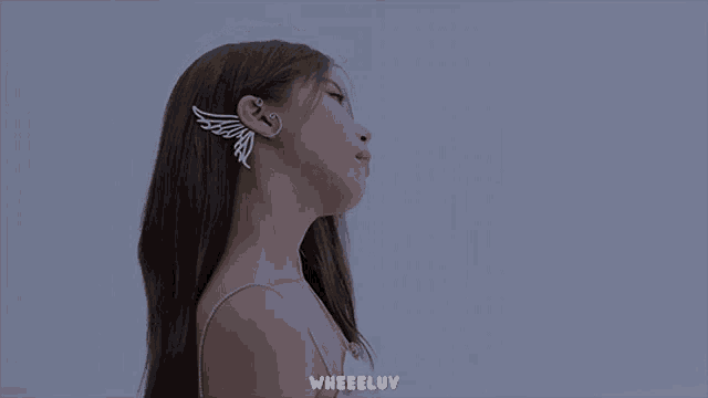 a close up of a woman 's face with the words wheeluv on the bottom right