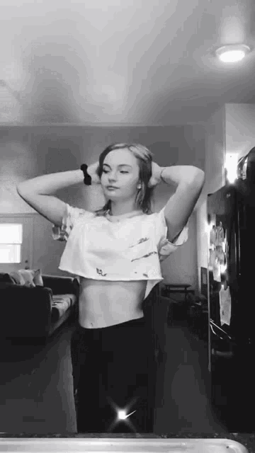 a woman is taking a selfie in front of a mirror