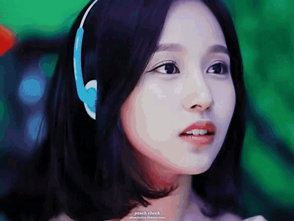 a close up of a woman wearing headphones with peach check written on the bottom right