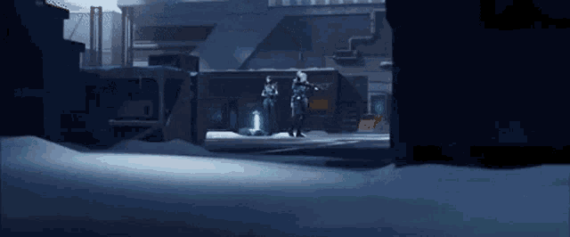 a couple of people are standing in the snow in a dark room