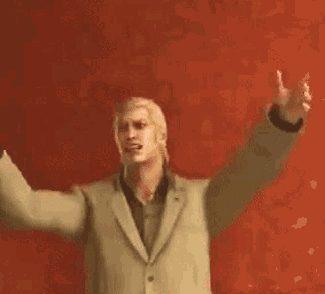 a man in a suit is dancing with his hands in the air .