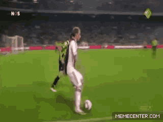 a soccer player is kicking a ball on a field with a memecenter.com logo in the corner