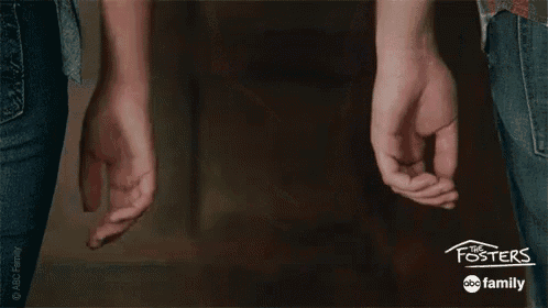 a man and a woman are holding hands in a room .