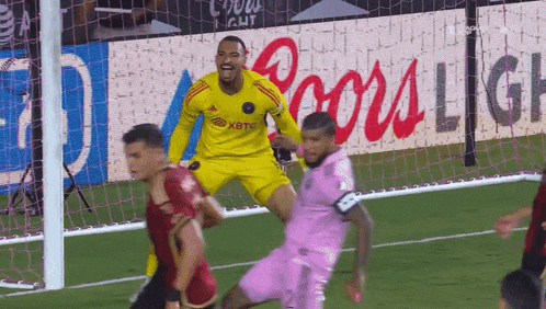 a soccer player wearing a yellow jersey that says xbtc on it