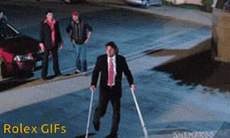 a man in a suit and tie is walking with crutches in front of a rolex logo