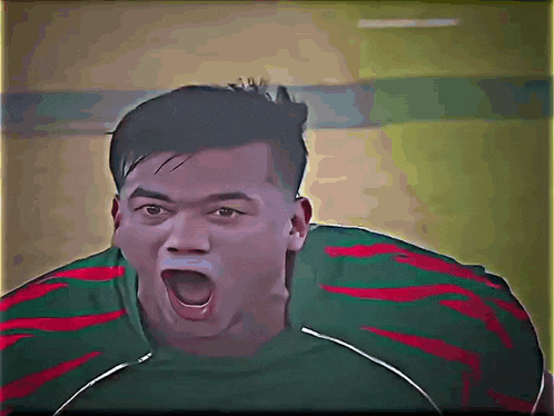 a man with his mouth open is wearing a green and red striped shirt