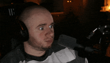 a man wearing headphones and a microphone has the number 116 on the back of his shirt