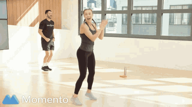 a man and a woman are doing exercises in a room with the words momento on the bottom right