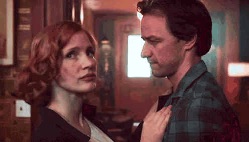 a man and a woman are standing next to each other and looking at each other in a room .