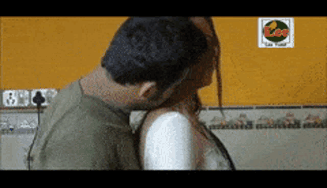 a man is kissing a woman on the neck