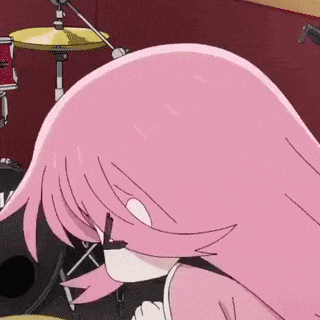a girl with pink hair is playing drums in a band and making a funny face .