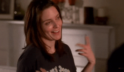 a woman wearing a black t-shirt that says ' rock n ' roll ' on it