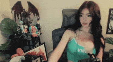 a woman in a green tank top that says vibe