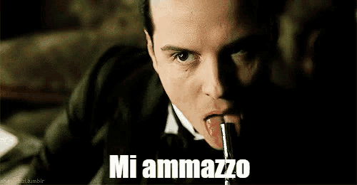 a man in a tuxedo is sticking his tongue out and saying mi ammazzo