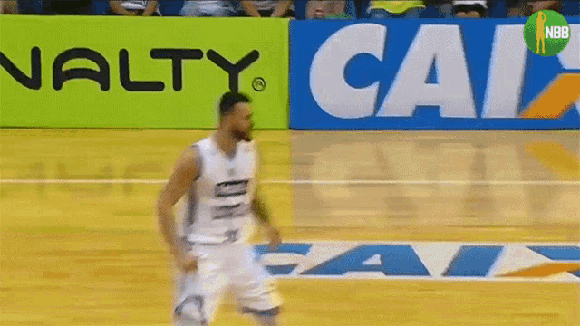 a man playing basketball in front of a sign that says calz