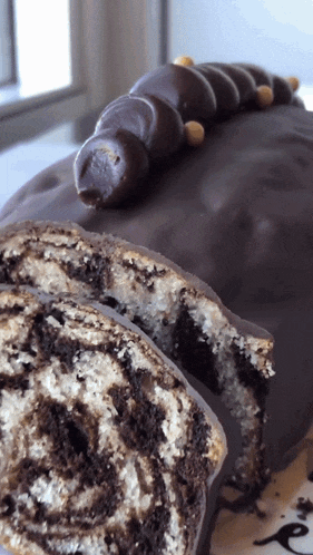 a close up of a chocolate cake with a slice taken out of it