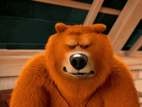 a close up of a stuffed bear with headphones around his neck