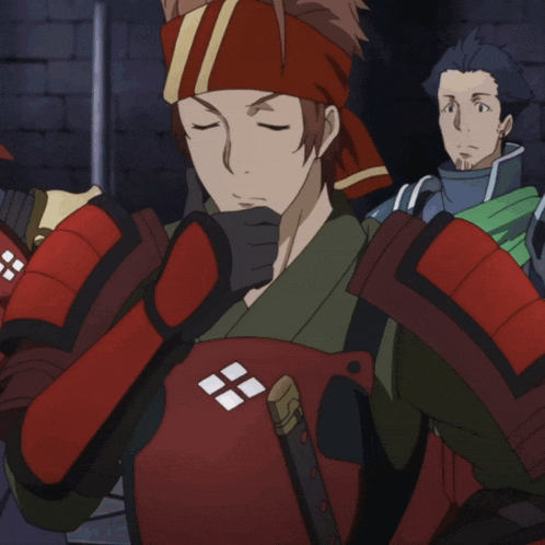 a man with a red headband holds his hand to his chin