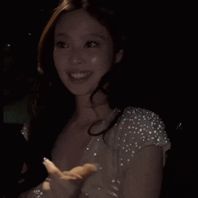 a woman in a white dress with sequins on the sleeves
