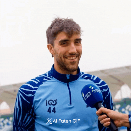 a man wearing a blue sweater with the number 44 on it