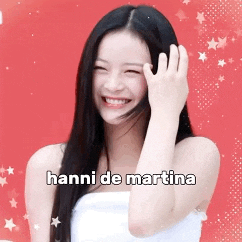 a woman with long black hair is smiling and covering her face with her hands .